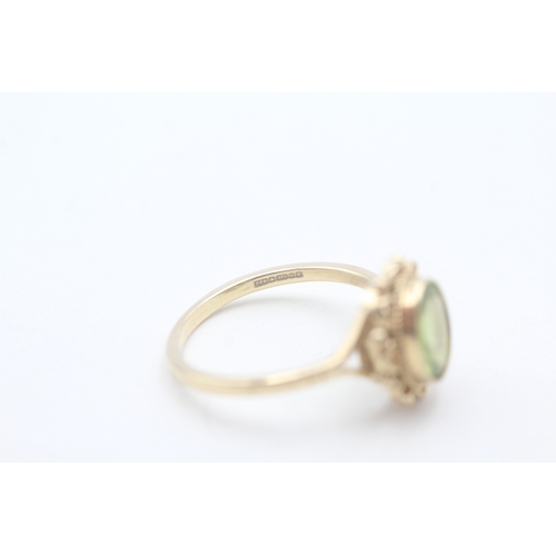 56 - 9ct gold and peridot ring (2.9g) Size P