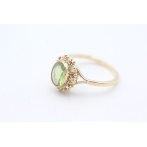 56 - 9ct gold and peridot ring (2.9g) Size P