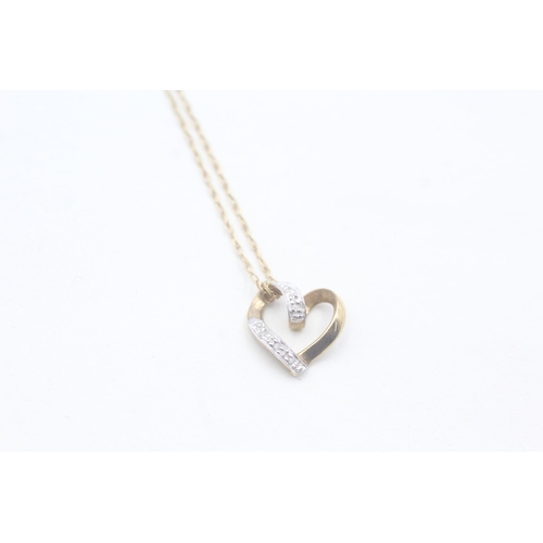 57 - 9ct gold heart shaped diamond pendant on chain (1.4g)