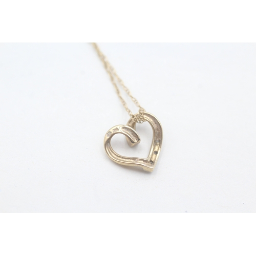 57 - 9ct gold heart shaped diamond pendant on chain (1.4g)