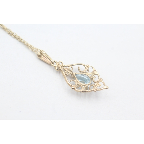 90 - 9ct gold and blue topaz pendant on chain (1.8g)