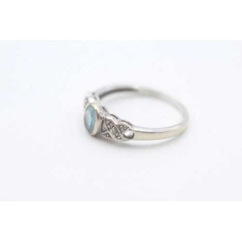 99 - 9ct gold blue topaz and diamond ring (1.7g) Size N