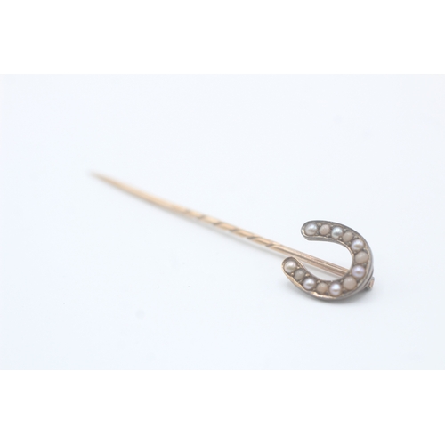 232 - 15ct gold antique seed pearl horseshoe stick pin with a 9ct gold pin (1.9g)