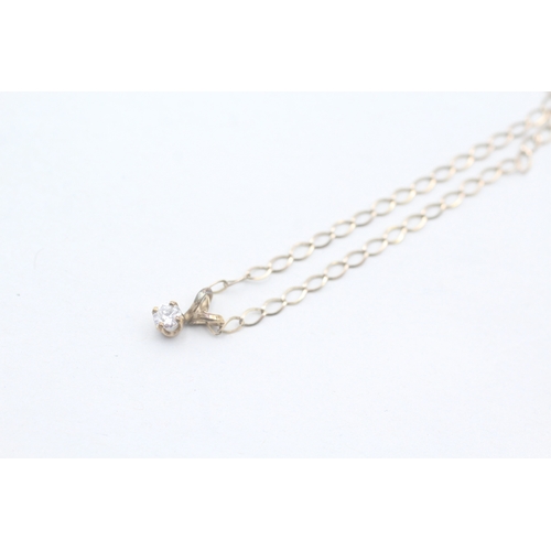 242 - 9ct gold single diamond pendant on chain (1.1g)