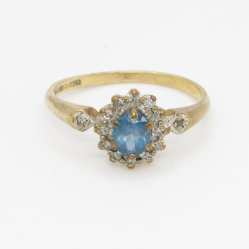 51 - 9ct gold blue topaz and diamond halo set ring (1.8g) Size M