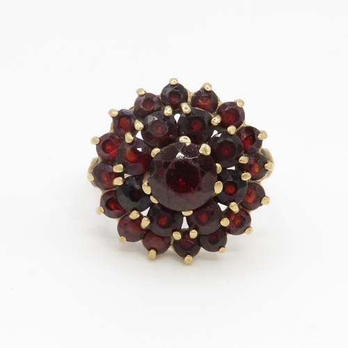 79 - 9ct gold garnet double halo cluster ring (5.4g) Size O 1/2