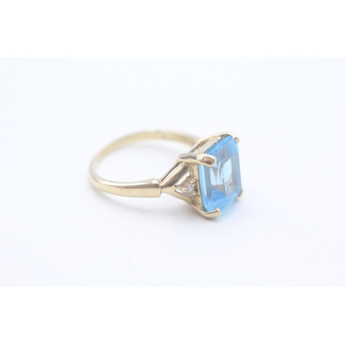 21 - 9ct gold claw set topaz and diamond ring (2.8g) Size K