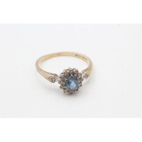 51 - 9ct gold blue topaz and diamond halo set ring (1.8g) Size M