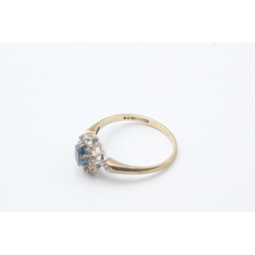 51 - 9ct gold blue topaz and diamond halo set ring (1.8g) Size M