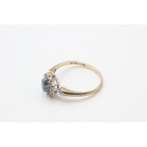 51 - 9ct gold blue topaz and diamond halo set ring (1.8g) Size M