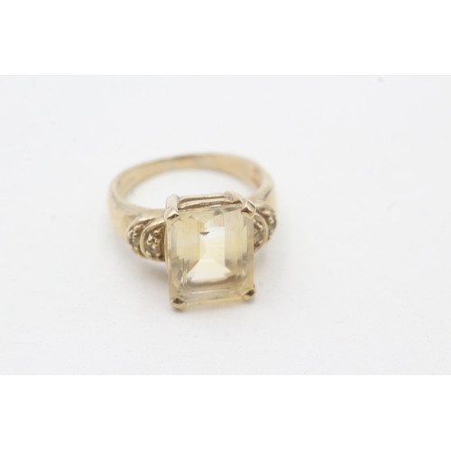 69 - 9ct gold citrine single stone ring with diamond sides (3.8g) Size K 1/2