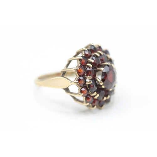 79 - 9ct gold garnet double halo cluster ring (5.4g) Size O 1/2