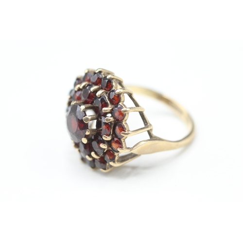 79 - 9ct gold garnet double halo cluster ring (5.4g) Size O 1/2