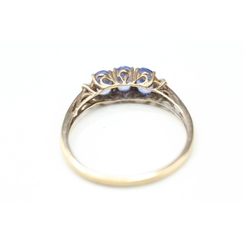 82 - 9ct gold tanzanite three stone ring with calibre cut diamond sides (2g) Size V