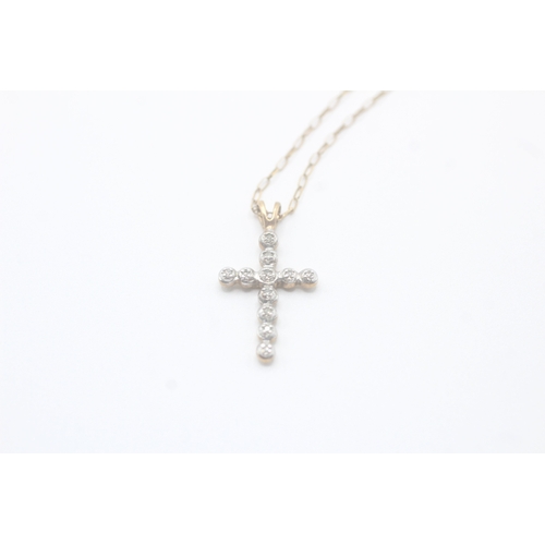 93 - 9ct gold diamond cross pendant on chain (1.6g)