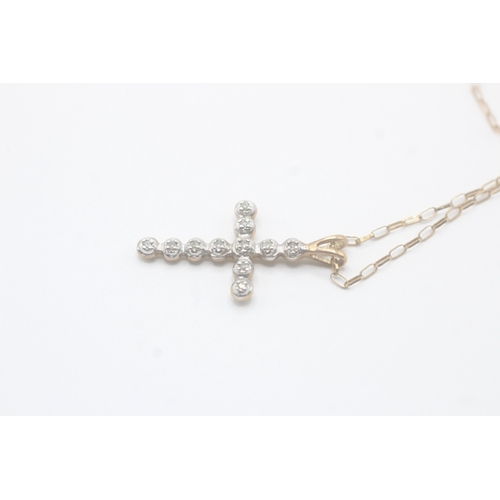 93 - 9ct gold diamond cross pendant on chain (1.6g)