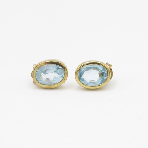 74 - 9ct gold blue topaz stud earrings (1.9g)