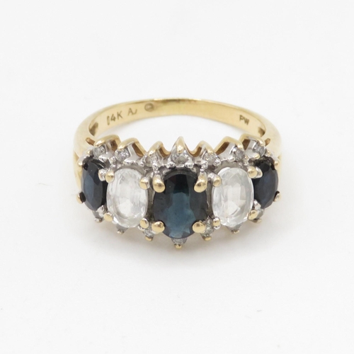 81 - 9ct gold diamond, white and blue sapphire row ring (4.2g) Size O