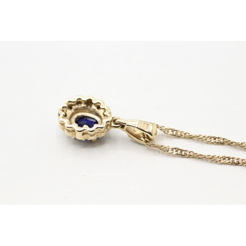 28 - 9ct gold blue gemstone and diamond halo pendant on chain (3.3g)