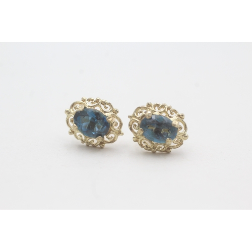 69 - 9ct gold blue topaz stud earrings (1.8g)