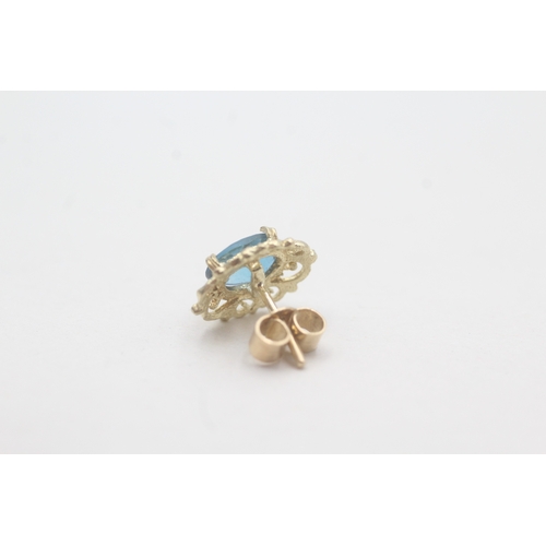 69 - 9ct gold blue topaz stud earrings (1.8g)