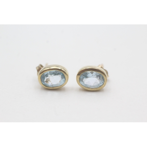 74 - 9ct gold blue topaz stud earrings (1.9g)