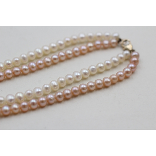 146 - 9ct gold twin strand cultured pearl bracelet (10.7g)