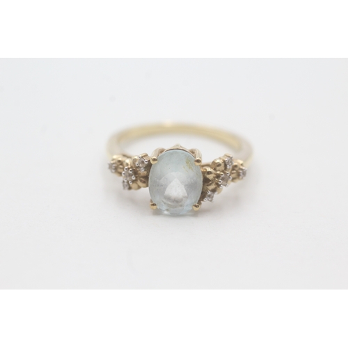 166 - 9ct gold aquamarine and white gemstone ring (2.9g) Size O