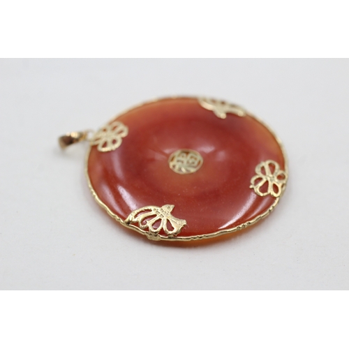 172 - 14ct gold jade circle pendant (10.9g)