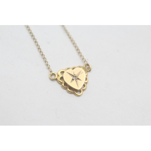 29 - 9ct gold heart and diamond pendant on chain (1.4g)