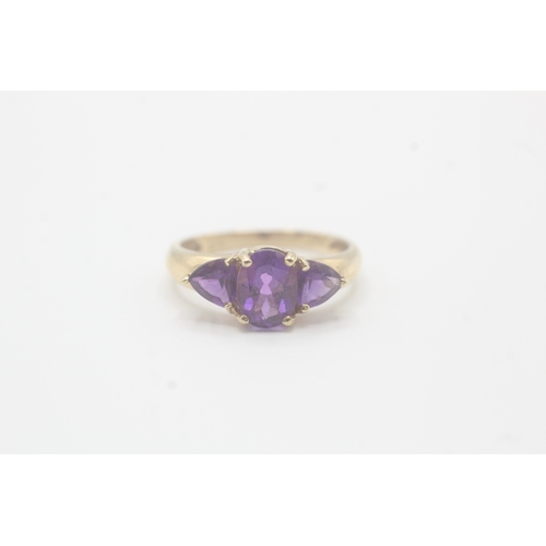 58 - 9ct gold amethyst three stone ring (2.2g) Size O