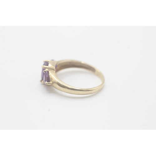 58 - 9ct gold amethyst three stone ring (2.2g) Size O