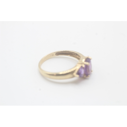 58 - 9ct gold amethyst three stone ring (2.2g) Size O