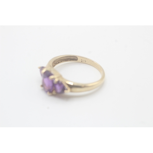 58 - 9ct gold amethyst three stone ring (2.2g) Size O