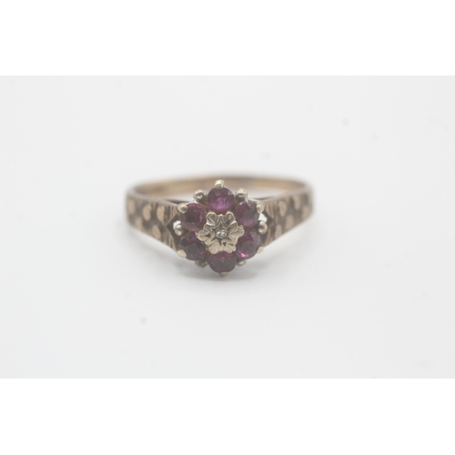 59 - 9ct gold diamond & ruby seven stone floral cluster ring (3g) As seen - slightly mishapen  Size P