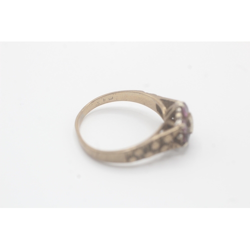 59 - 9ct gold diamond & ruby seven stone floral cluster ring (3g) As seen - slightly mishapen  Size P