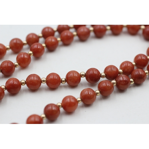 64 - 14ct gold clasped red jade beaded necklace with gold spacers (40.8g)