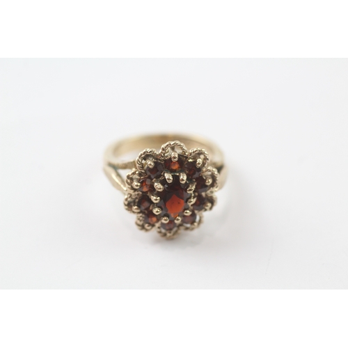 96 - 9ct gold garnet cluster cocktail ring (5.2g) Size K