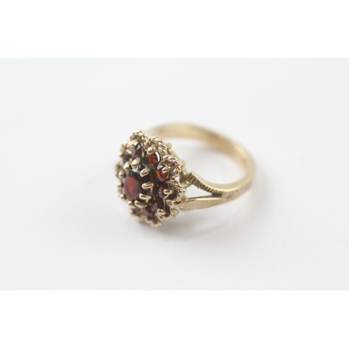 96 - 9ct gold garnet cluster cocktail ring (5.2g) Size K