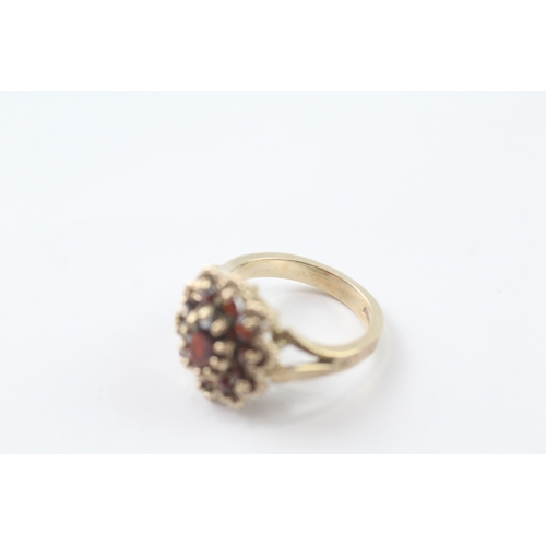 96 - 9ct gold garnet cluster cocktail ring (5.2g) Size K