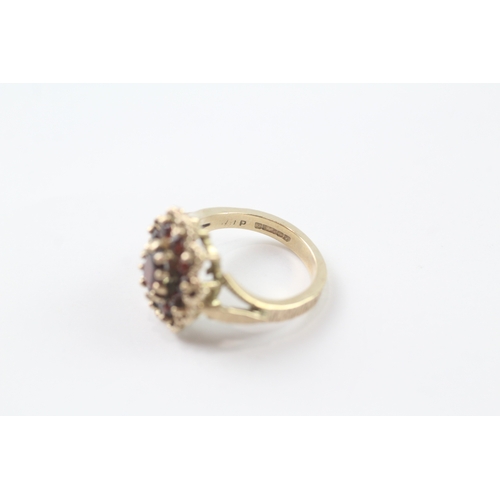 96 - 9ct gold garnet cluster cocktail ring (5.2g) Size K