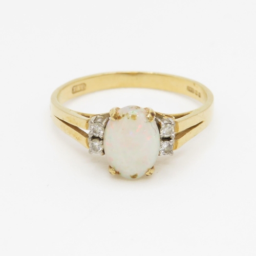 94 - 18ct gold opal and diamond set dress ring (2.2g) Size M