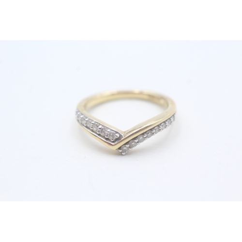 65 - 18ct gold diamond set wishbone ring (3.7g) Size M