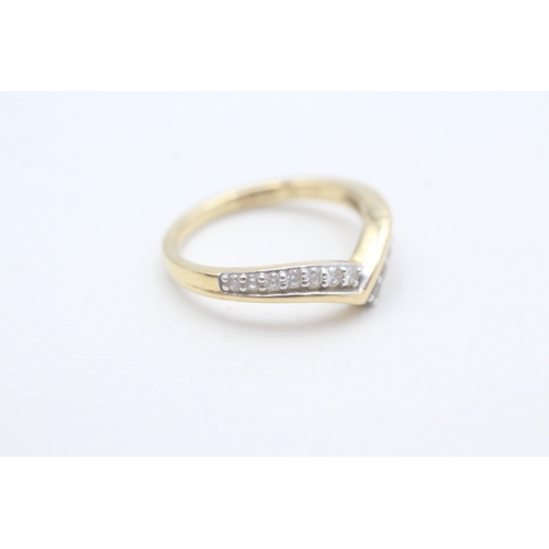 65 - 18ct gold diamond set wishbone ring (3.7g) Size M