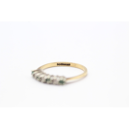 111 - 9ct gold emerald and diamond set seven stone eternity ring (1.6g) Size N 1/2