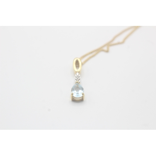 164 - 9ct gold pear cut blue topaz & diamond drop pendant necklace (2.3g)