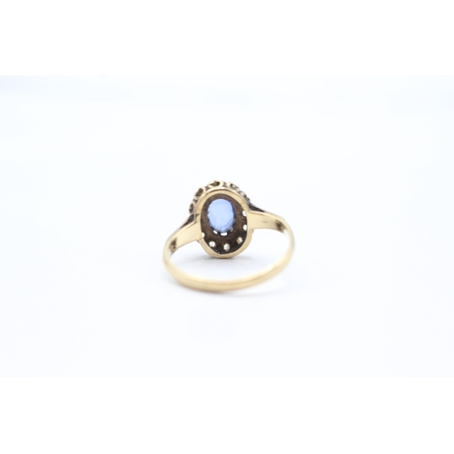 94 - 9ct gold synthetic sapphire & synthetic spinel oval halo ring (2.2g) Size M