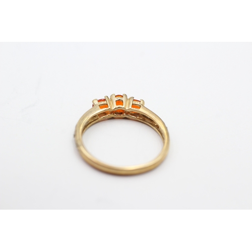 116 - 9ct gold fire opal and diamond trilogy ring (1.7g) Size M