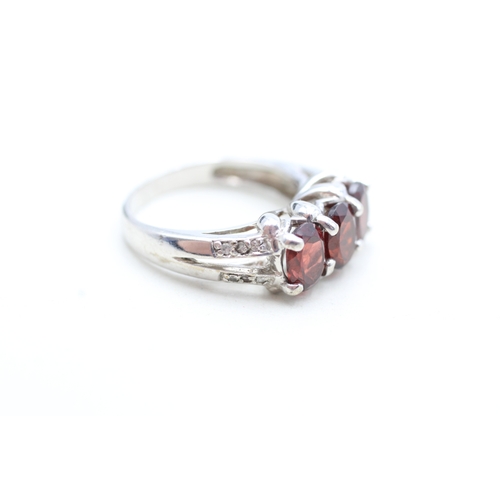 12 - 9ct white gold garnet and white gemstone set dress ring (4.8g) Size N