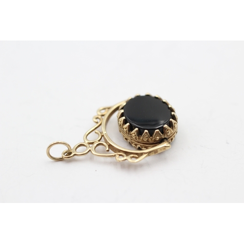 146 - 9ct gold onyx and bloodstone spinner fob (3.2g)